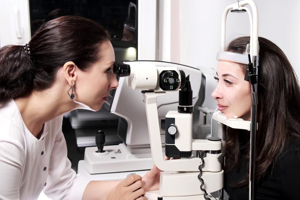 Female Ophthalmologist examining a patient's eyes