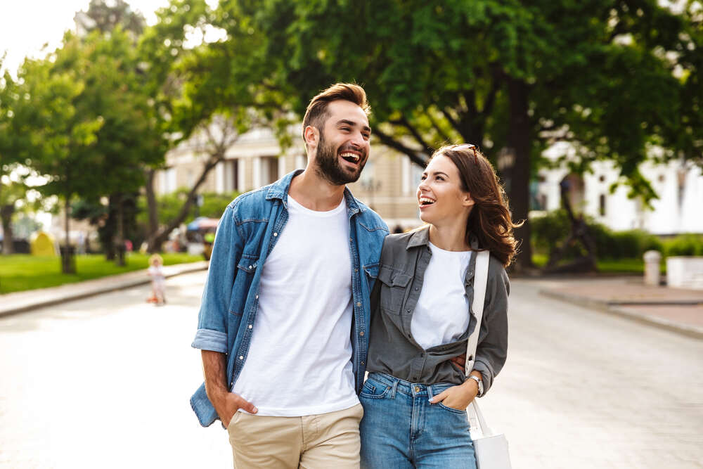 young couple walking through city without glasses