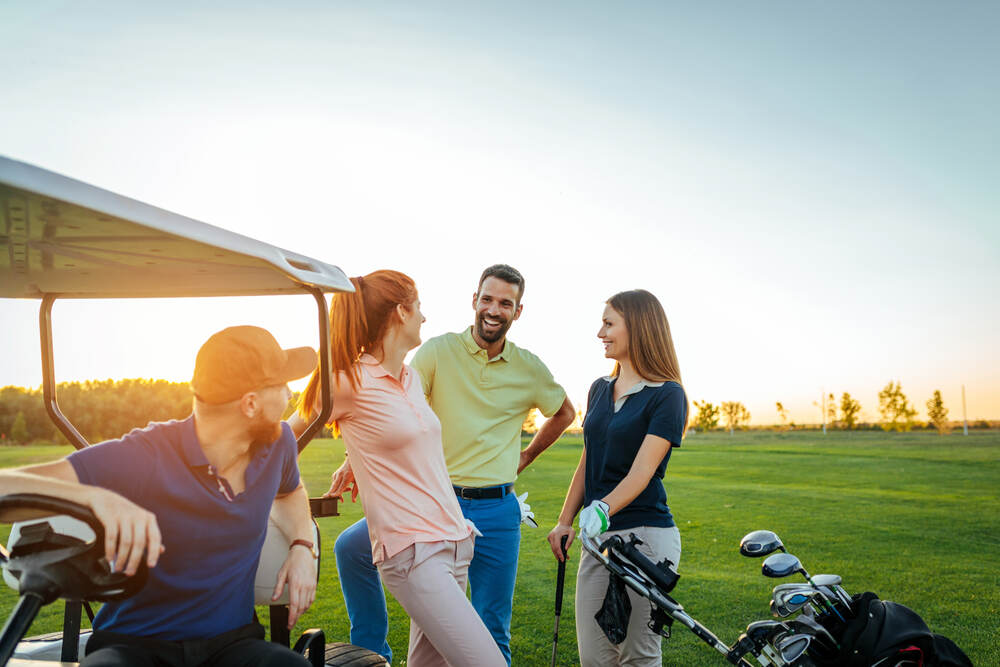 young couples golfing while wearing no glasses