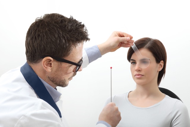 Optometrist examining eyesight Woman