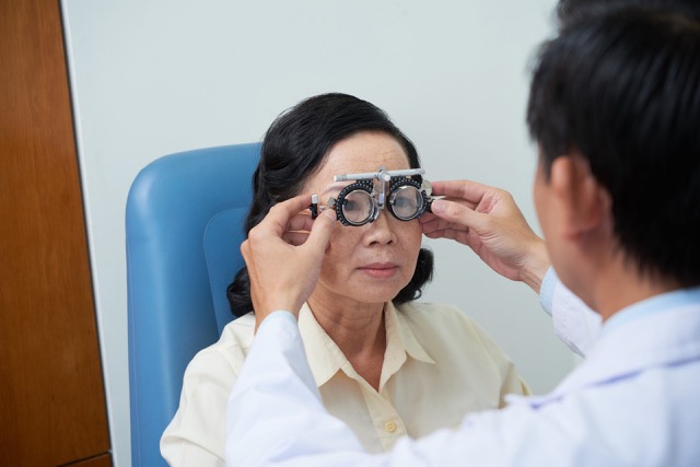 ophthalmologist putting special glasses with trial lens