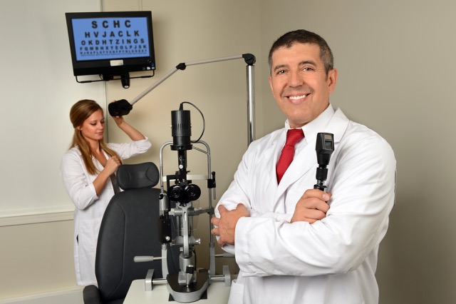 Eye doctor and his assistant in the examination room