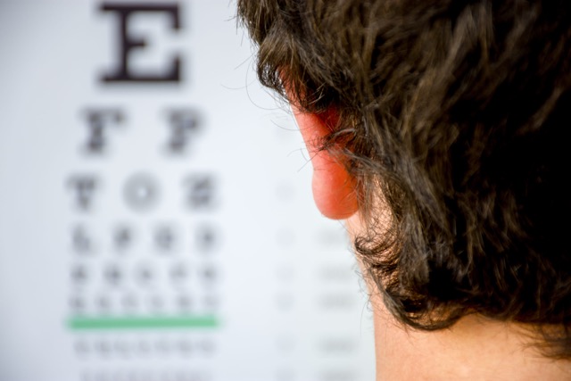 man struggling with myopia or nearsightedness