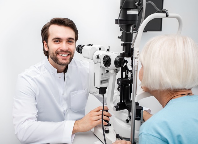 Ophthalmologist checking eyesight of an elderly patient