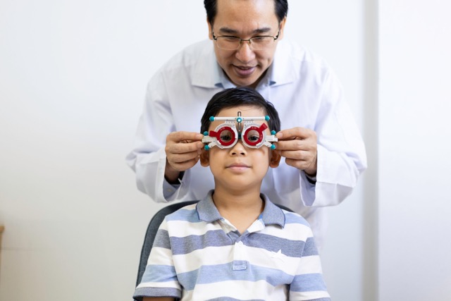 An Ophthalmologist examines the child's eyesight