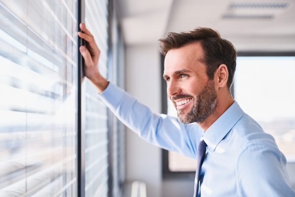 young business man smiling in the office without glasses